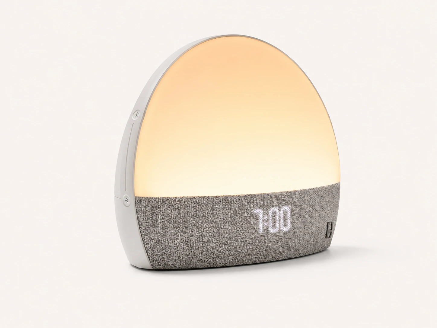 Side angle product view of Hatch Restore Smart Alarm Clock showing its curved design Side angle product view of Hatch Restore Smart Alarm Clock showing its curved design